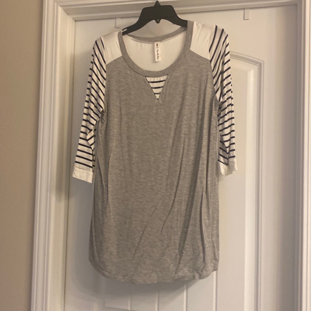 Gray three quarters sleeve navy and white striped shirt.